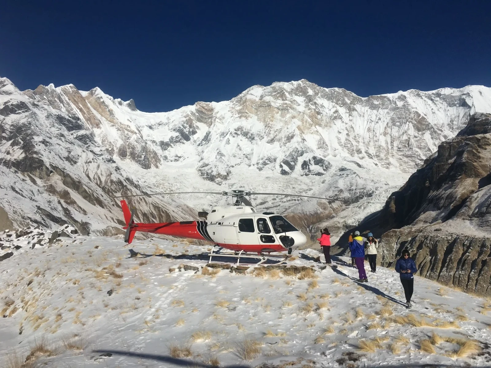 A group of people enjoying the helicopter landing tour in Annapurna Base Camp organised by North Nepal Trek
